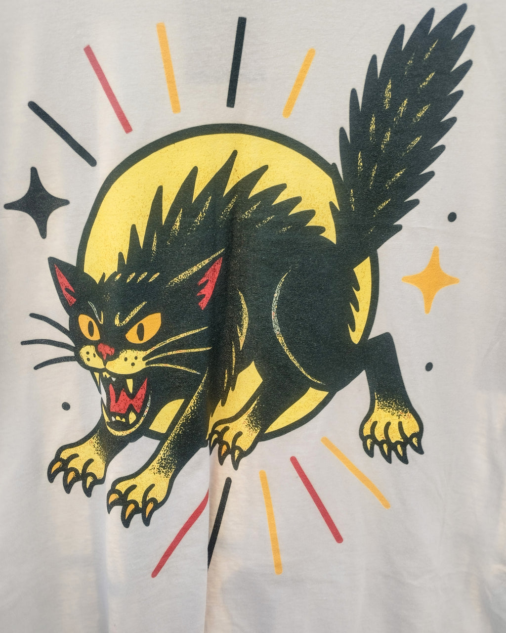 Black cat tattoo design with yellow circle and colorful lines on a light gray background