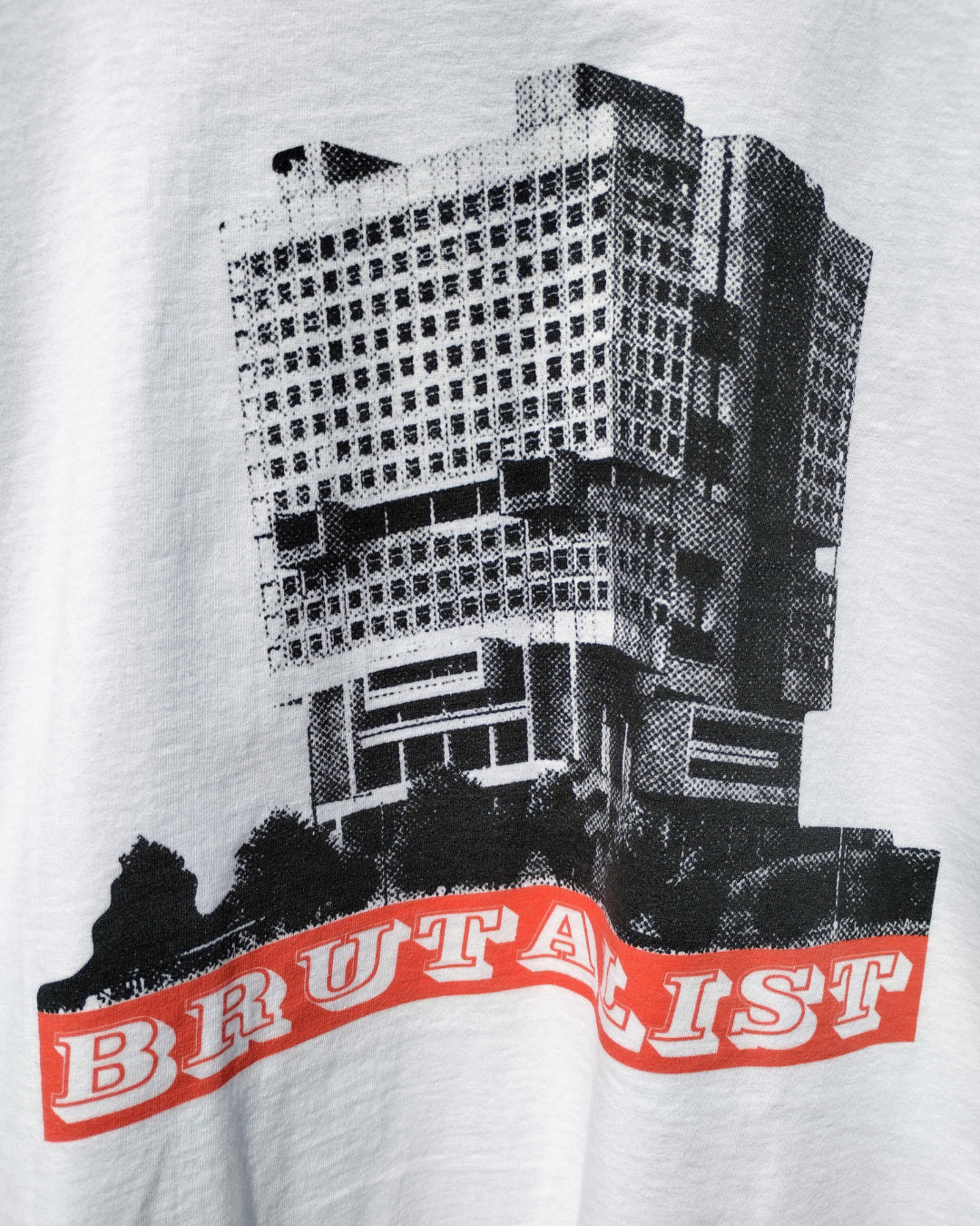 T-shirt with a graphic of a building and the word 'BRUTALIST' on a white background
