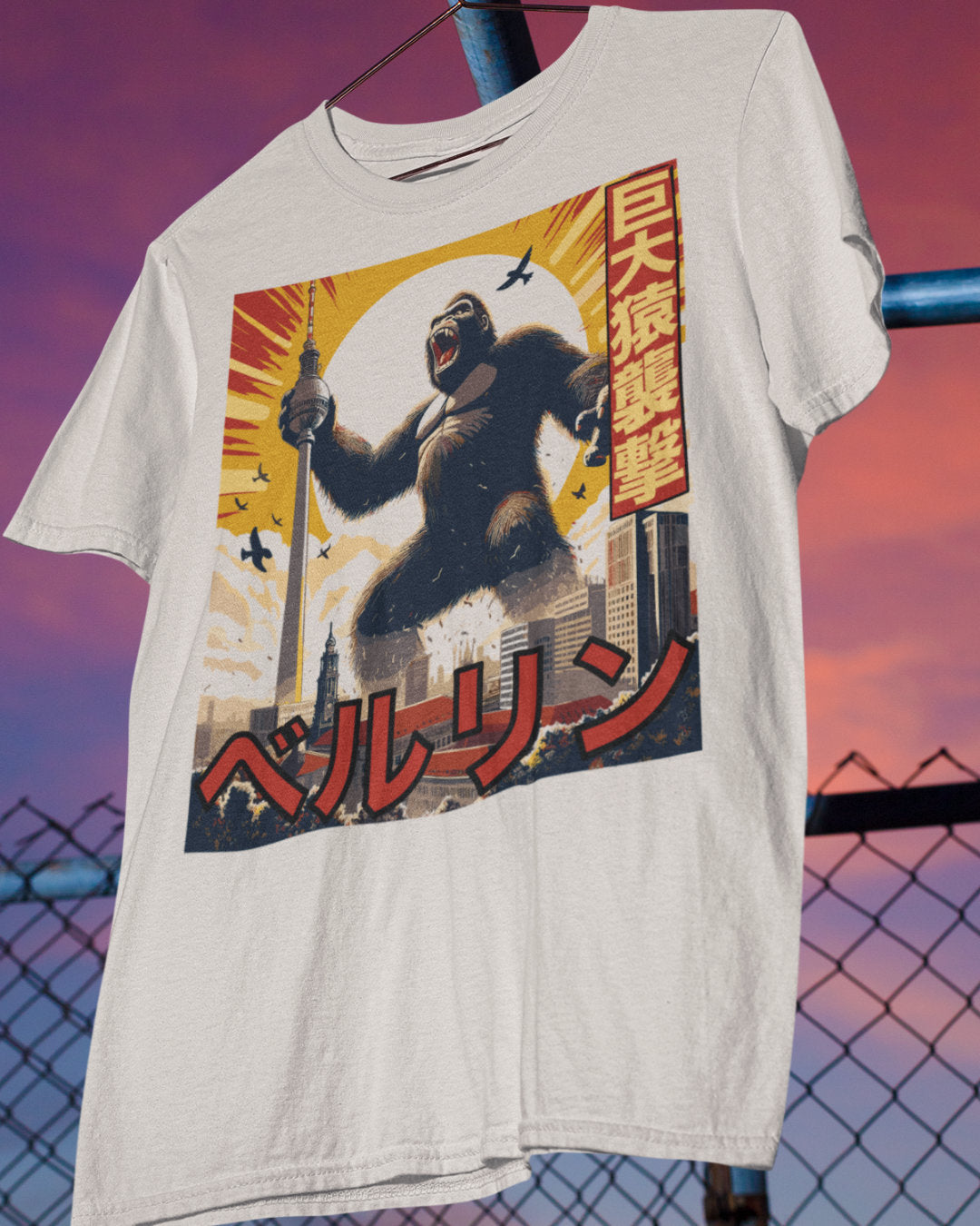 Graphic T-Shirt of King Kong in Berlin on a hanger against a sunset sky