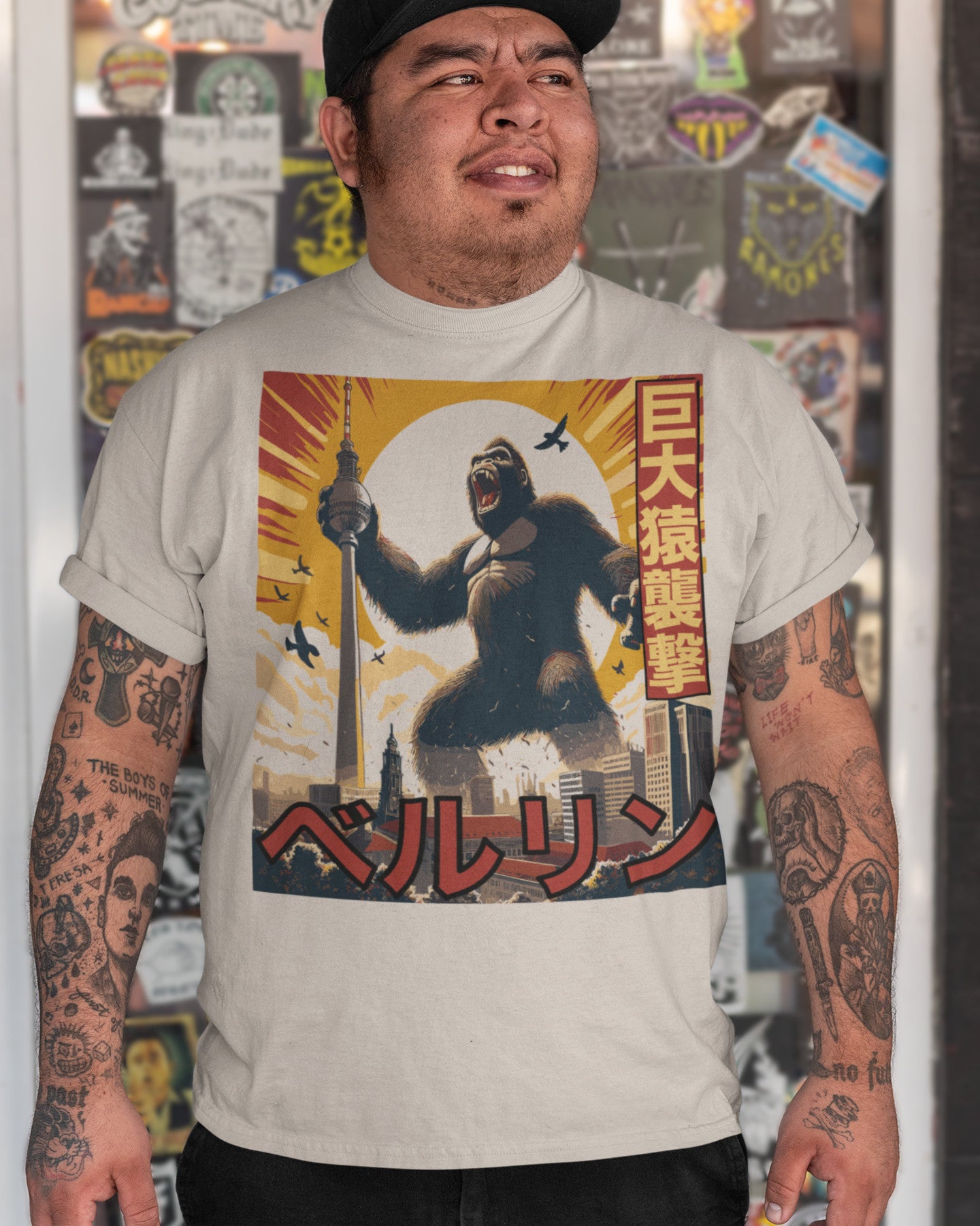 Man wearing a white graphic t-shirt featuring King Kong