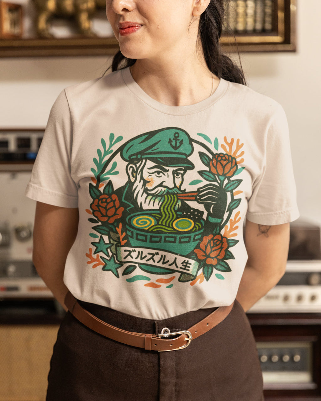  a t-shirt with a graphic design of a sea captain eating noodles.