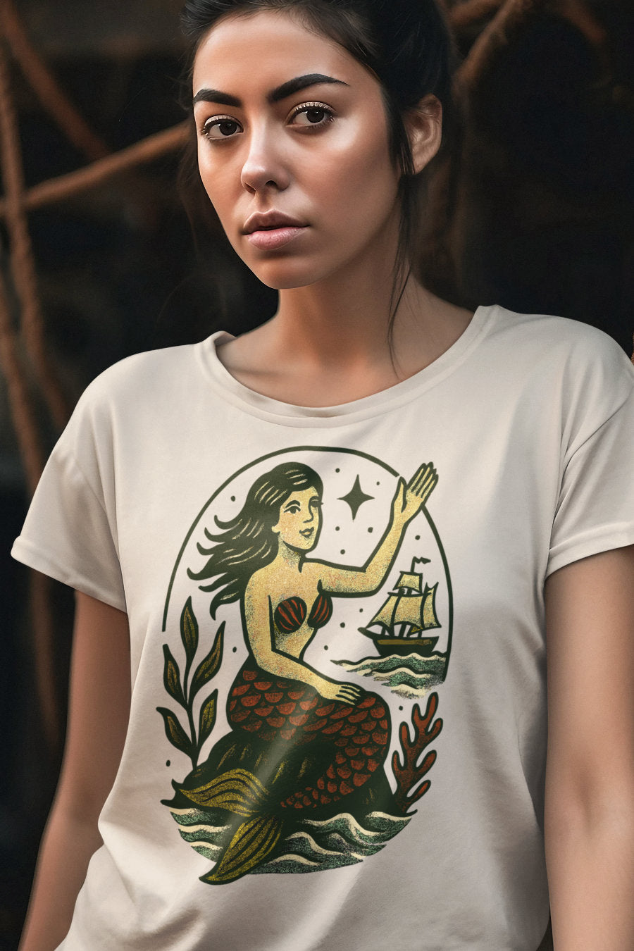 Woman wearing a t-shirt with a mermaid graphic design.