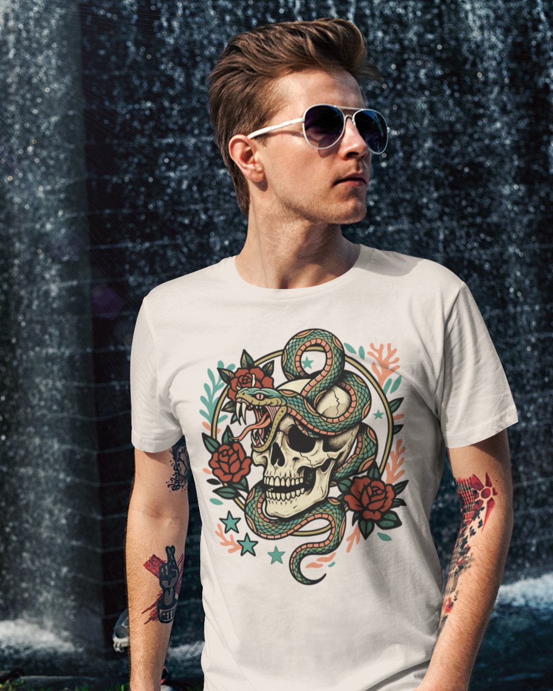 Man wearing a t-shirt with a snake and skull design in front of a water curtain.