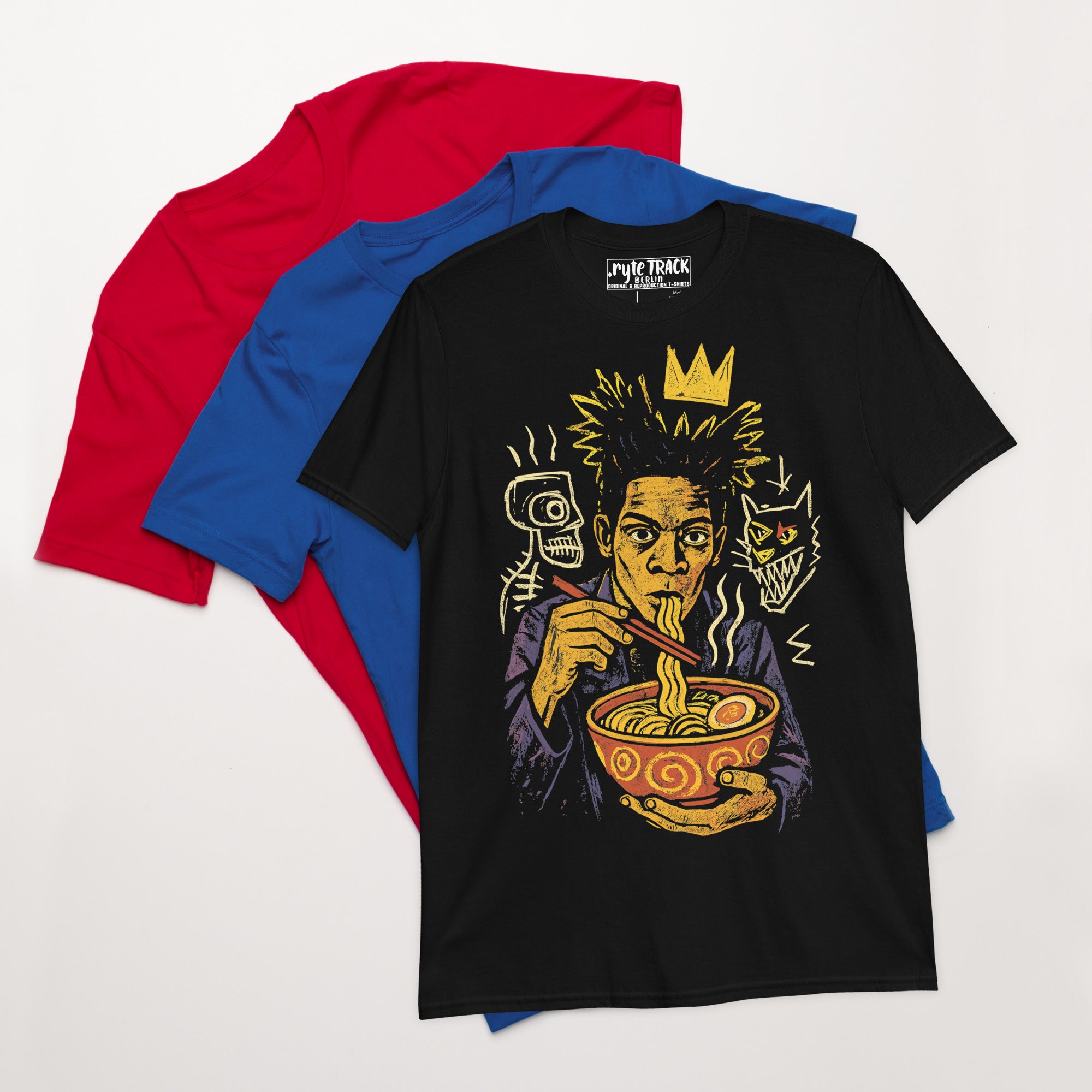 Black t-shirt with a graphic design of a person eating ramen noodles with some other shirts