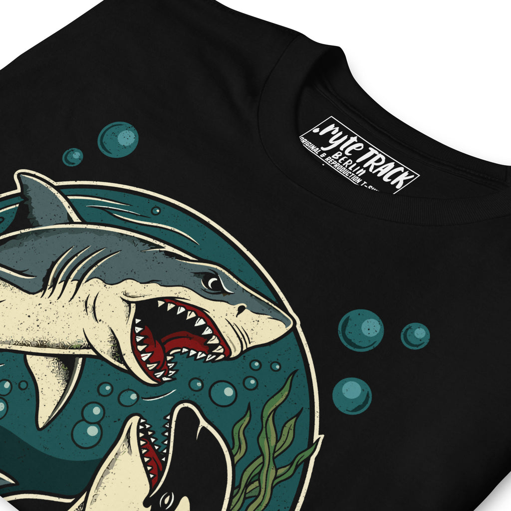close up  detail of a t-shirt featuring a shark and a whale
