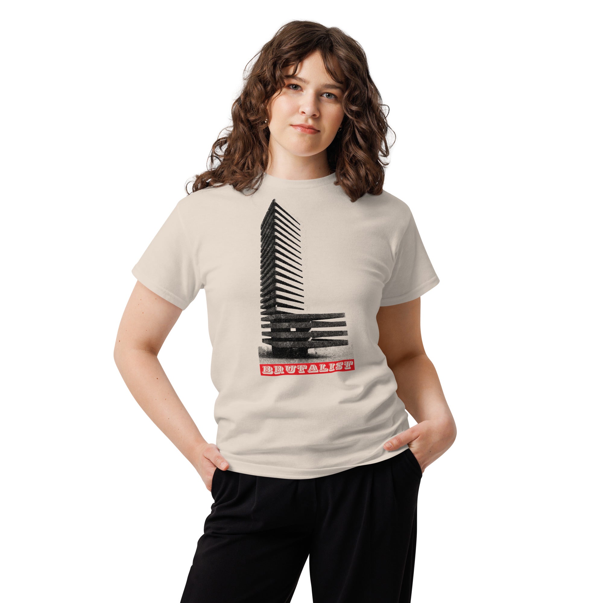 A woman modeling a light beige t-shirt with a black piano keys graphic and the word 'Brutalist' in red text, paired with black pants, against a plain white background.