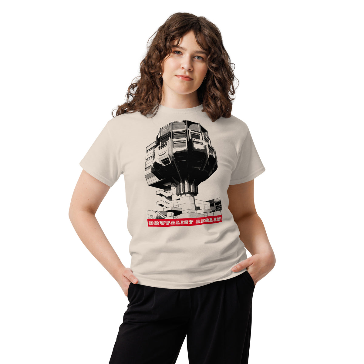 woman wearing a graphic t-shirt with an image of a brutalist building
