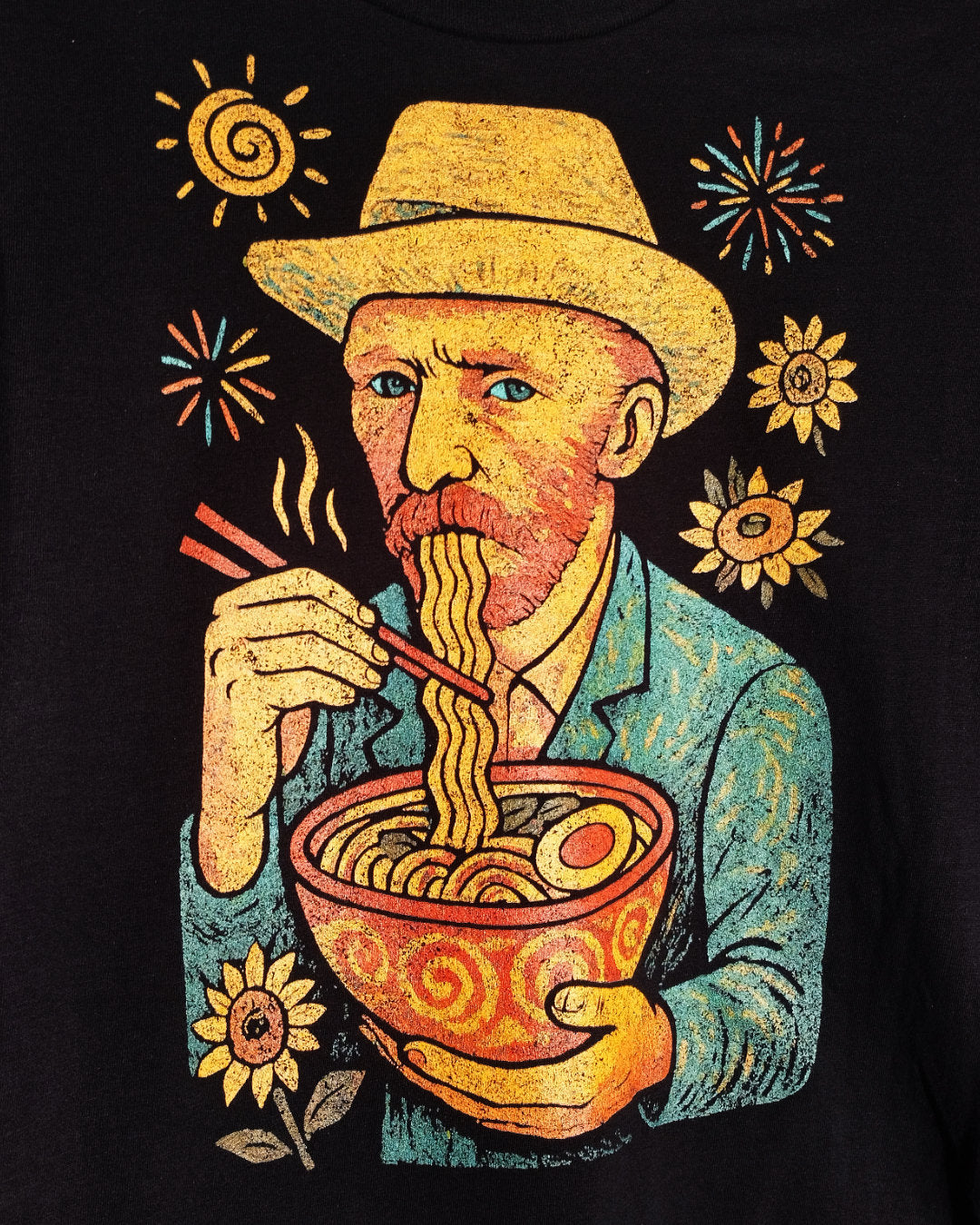 Illustration of a man with a hat eating noodles from a bowl surrounded by suns and flowers on a black shirt.
